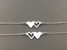 The two heart bracelet measures 3/4 inch and is made of stainless steel Chain length: 6 inches with a 1-inch extender made of stainless steel Color: Silver This listing is for set of 2 bracelets. For quantity of 1 , you will receive 2 bracelets. Comes in gift box ready for gifting Each bracelet is custom made by hand with love and care in my workshop. Best Friends Bracelet, Friendship Jewelry For 2, Sister Bracelet For 2, Bracelets For Besties, Best Friend Bracelets For 2, Friendship Bracelets Silver, Matching Bracelets For Best Friends, Sister Necklaces For 2, Sister Bracelets