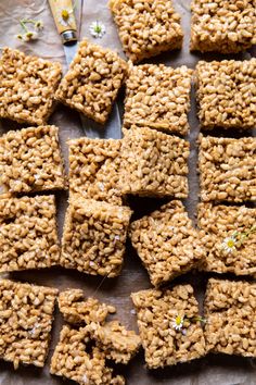 homemade granola bars are arranged on a sheet of parchment paper and ready to be eaten