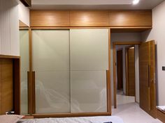 a bedroom with sliding glass doors and wood trimmings on the walls, along with a bed