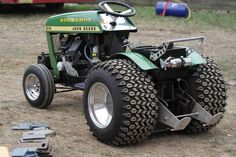 a tractor that is sitting in the dirt with it's front wheels up and tires down