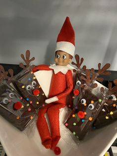 an elf is sitting on top of some chocolate bars