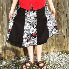 "Here is a classy looking black, white and red knee length skirt for women. Made with two coordinating cotton fabrics, this handmade a-line skirt is perfect for many different occasions! This skirt has 8 panels alternating between a solid black fabric and a white print with black outlined flowers and bold red accents here and there to add a little bit of color. Depending on the look you want, a black, white, or red top would all look great with this Summer skirt This skirt has an elastic waistba Black A-line Retro Skirt, Black Retro A-line Skirt, Black Cotton Flared Skirt, Red Cotton Flared Skirt, Black Cotton Knee-length Skirt, Red Flared Cotton Skirt, Black Knee-length Cotton Skirt, Red Cotton Midi Skirt, Black Cotton Skirt With Gathered Details