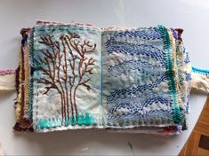 a piece of cloth with an embroidered tree on it