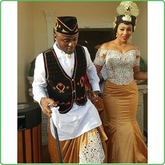 a man and woman dressed in traditional african clothing