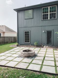 a backyard with a fire pit in the middle