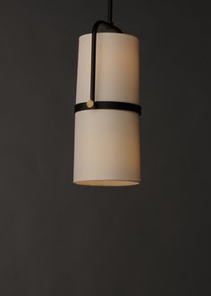 a black and white light hanging from a ceiling