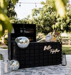 an outdoor bar with mirrored balls on it