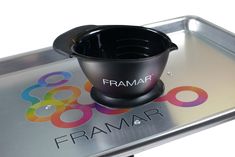 a metal tray with a black bowl on it and the word framar printed on it