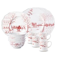 a red and white dinner set with trees on it