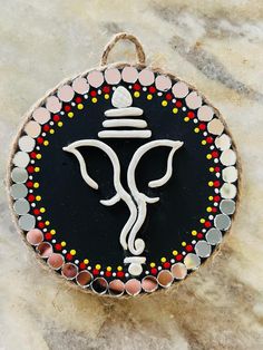 a black and white ganeshi ornament on a marble surface