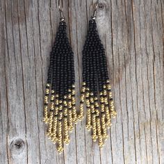 Native American earrings. Arrow pattern including seed beads in matte and metallic with warm colors black and gold. These earrings measure 3 1/2 inches with your choice of ear wires. If you want a custom order :  contact me . Each of my creations is inspired by nature . Thank you and happy ! Black Beaded Earrings With Round Beads And Fringe, Black Beaded Fringe Earrings With Round Beads, Black Beaded Tassel Earrings With Round Beads, Black Fringe Earrings With Round Beads, Gold Beaded Earrings With Fringe, Adjustable Gold Beaded Earrings With Black Beads, Black Bohemian Beaded Earrings With Gold Beads, Gold Beaded Fringe Earrings With Adjustable Fit, Adjustable Black Beaded Tassel Earrings