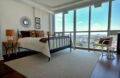 a bedroom with a large window and a bed in it's centerpieces