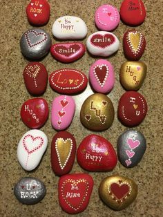 some rocks with hearts and words on them