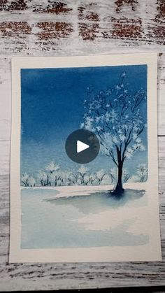 a card with an image of a tree in the snow and a video playing button