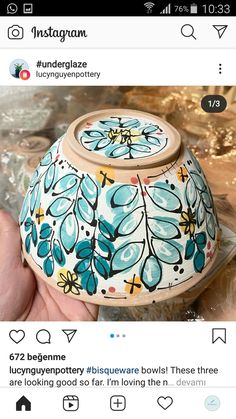 a hand holding a small pot with flowers painted on it's sides and the words instagram below