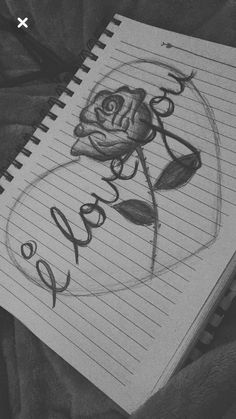 a drawing of a rose with the word roses written in cursive writing on lined paper