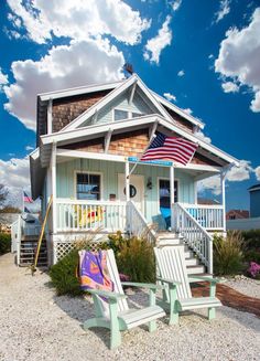 two lawn chairs sitting in front of a house