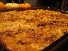 a casserole dish in a pan with pumpkins behind it