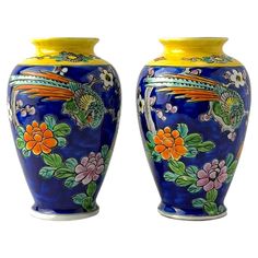 two blue vases with colorful designs on them