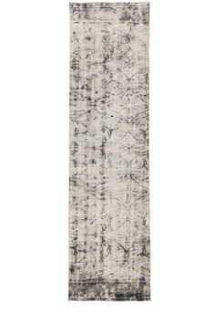 an antique rug with faded black and white colors