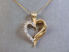 "THIS IS A VINTAGE ESTATE WOMEN'S 14K GOLD FINE NECKLACE AND 14K GOLD HEART PENDANT WITH DIAMOND CHIPS. NECKLACE MEASURES 16\" LONG. HEART PENDANT IS MARKED 14K GOLD AND MEASURES 3/4\" LONG X 3/4\" WIDE. TOTAL WEIGHT OF ITEM IS 5.35g. WOULD MAKE A LOVELY GIFT FOR THAT SOMEONE SPECIAL. ANY OTHER QUESTIONS, PLEASE ASK. BE SURE TO CHECK OUT SOME OF MY OTHER GREAT ITEMS UP FOR SALE. THANK YOU" Gold Heart-shaped Diamond Necklace For Weddings, Gold Heart Cut Diamond Necklace For Wedding, Gold Heart Cut Diamond Necklace For Formal Occasions, Gold Brilliant Cut Heart Necklace For Formal Occasions, Gold Brilliant Cut Heart Necklace For Formal Events, Gold Heart Necklace With Diamond Cut For Formal Occasions, Formal Gold Heart Necklace With Diamond Cut, Gold Diamond Cut Heart Necklace For Formal Occasions, Elegant Yellow Gold Heart Necklace With Hallmark