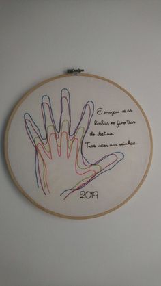 the embroidery is hanging on the wall and it has an embroidered hand that says congratulations to someone who was born in 2009