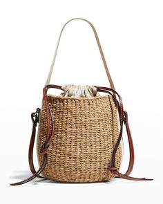 "Find CHLOÉ Woody Small Mifuko Basket Bag In Fair Trade Paper Embellished With Linen on Editorialist. Chloe x Mifuko \"Woody\" bucket bag in straw, cotton, and leather Branded flat web top handle Flat shoulder strap Drawstring closure Leather lining Approx. 6.3\"H x 6.7\"W x 6.3\"D Made in Italy" Natural Color Bucket Bag For Daily Use, Woven Leather Bucket Shoulder Bag, Natural Fiber Bucket Bag, Travel Woven Leather Bucket Bag, Woven Leather Bucket Bag For Travel, Beige Woven Leather Bucket Bag, Jute Bucket Bag For Daily Use, Jute Bucket Bag With Bamboo Handle, Travel Bucket Bag With Woven Leather