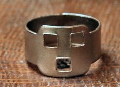 a silver ring that has been made to look like it is in the shape of a cross