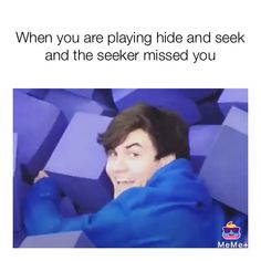 a man in blue jacket laying on top of purple cubes with text that reads, when you are playing hide and seek and the speaker missed you