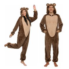 a man and woman in animal onesuits posing for the camera with their hands up