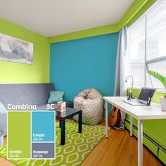 a living room with green and blue walls, wood flooring, and furniture in it