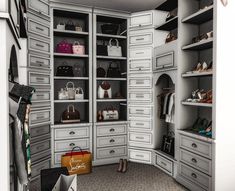 a walk in closet filled with lots of drawers and handbags on top of shelves