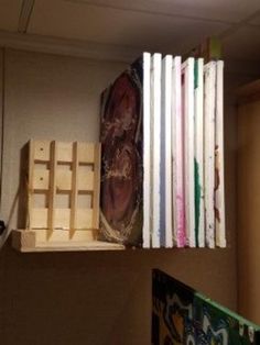 some books are stacked on top of each other in an office cubicle, and one is being made out of wood pallets