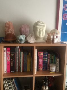 a book shelf filled with books and figurines on top of eachother