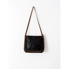 This is an original vintage American school bag circa 1910-1920. The painted black canvas bag features natural toned trim. It has a pocket on the front with a flap top closure. Leather straps would have buckled the bag closed. The silver tone buckles remain. It has a simple, long canvas strap.   ADDITIONAL MEASUREMENTS Strap drop : 16.5" Vintage Coated Canvas Shoulder Bag With Detachable Strap, Black Leather Trim Flap Shoulder Bag, Everyday Use Rectangular Coated Canvas Flap Bag, Black Rectangular Satchel With Canvas Lining, Vintage Flap Bag With Adjustable Strap For Daily Use, Everyday Rectangular Saddle Bag With Leather Trim, Black Saddle Bag With Leather Trim For Travel, Canvas Satchel Shoulder Bag With Leather Lining, Black Canvas Satchel With Detachable Strap