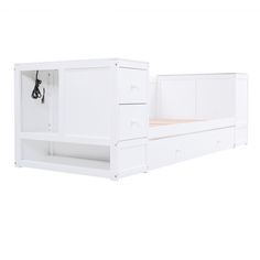 a white bed with two drawers on each side and a pull out shelf above it