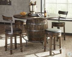 a kitchen table with stools and a wine barrel in the center, next to a window