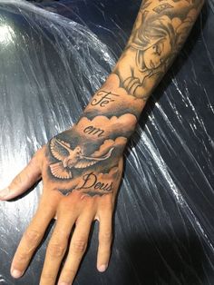 a person's hand with tattoos on it