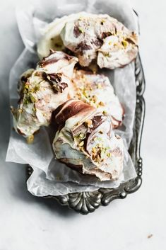 some type of bread with nuts on it in a metal tray next to other food items