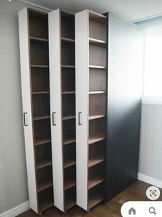 an empty room with two tall bookshelves next to each other