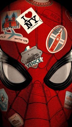 a close up of a spiderman mask with many stickers on it