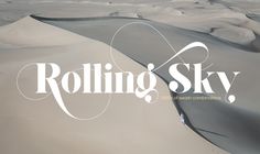 the logo for rolling sky is shown on top of an image of desert sand dunes