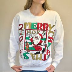 Vintage 80s/90s White Christmas Sweatshirt/Sweater Featuring A Thumbs Up Santa Painting "Noel" With Rudolph. "Merry Christmas" And "Ho Ho Ho" Are Also Boxed Around The Santa Graphic In Colors Of Red, Green, Black, White (Puff Paint), And Metallic/Sparkly Gold (Doesn't Shed Glitter). Ribbed Bottom Band And Crew Neck. Thinner Sweatshirt And Soft, Especially On The Inside. Good Vintage Condition-- New Old Stock With A Tag, But Does Have Some Minor Pilling From Age, A Tiny Spot On The Arm And Tiny P Retro White Winter Sweatshirt, Retro White Sweatshirt For Winter, White Retro Winter Sweatshirt, Retro White Sweater With Letter Print, White Retro Sweater With Letter Print, Retro White Crew Neck Sweater, Retro Crew Neck Tops For Winter, Casual Holiday Sweater With Graphic Print, Retro Long Sleeve Christmas Sweater