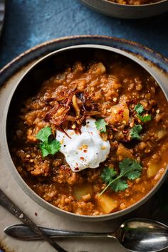 a bowl filled with soup and topped with sour cream