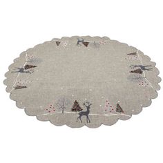 a round placemat with reindeers and trees on it