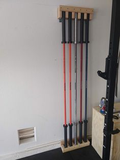 there is a rack with skis and poles in the room on the wall behind it