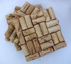 a pile of wine corks sitting on top of a white table next to each other