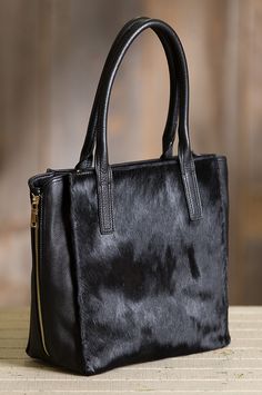 Fashioned of pebbled cowhide leather, this soft, sturdy bag showcases a hair-on front panel, while side zippers allow expansion for extra space. Free shipping + returns. Tote Leather Bag, Leather Tutorial, Business Travel Bag, Cowhide Handbags, Cowhide Bag, Fur Bag, Cow Skin, Handbag Heaven, Tote Bag Pattern