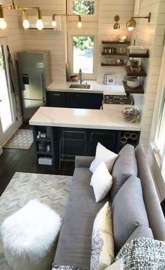 a living room and kitchen area in a tiny home