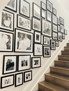 a staircase with many framed photos on the wall